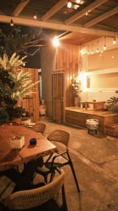 a patio with a table and chairs and a bench at 夏漾旅店Summer Delight 包棟民宿 in Nanwan