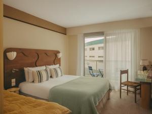 a hotel room with a bed and a window at Hotel Coeur Marin in Les Sables-d'Olonne
