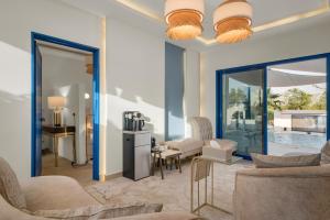 a living room with two couches and a table at Santorini check in in Ras al Khaimah