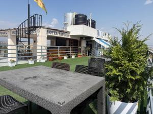 a table and chairs on the roof of a building at Hotel Tapowan - Near Tribhuvan International Airport in Kathmandu