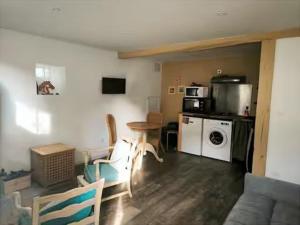 a living room with a table and a kitchen at Limousin, Saint Vitte sur Briance Vacances au Mazet de Nova in Martageix +21 photos