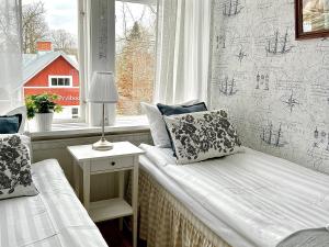 a small room with a bed and a window at Göta Hotell in Borensberg +14 photos