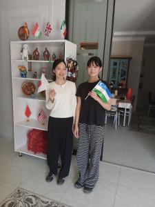 two women standing in front of a shelf at Xonobod НОТЕL in Khiva
