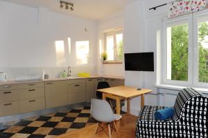 a kitchen with a table and a couch and a table at Studio Iwicka in Warsaw