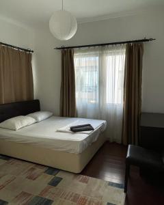 a bedroom with a bed and a large window at Rix Palm Apartments in Kyrenia +136 photos