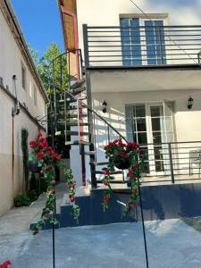 a stairway with red flowers in front of a building at Manika Grigoleti in Grigoleti +1 photo