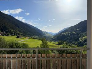 a view of a valley from a fence at Disentis-Mustér Ski Apartment in Disentis
