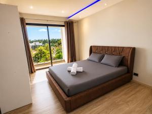 a bedroom with a bed with a white bow on it at Oaks Penthouse - Flic en Flac in Flic-en-Flac
