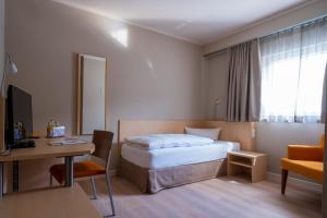 a hotel room with a bed and a desk at Rebhan's Klassik in Stockheim