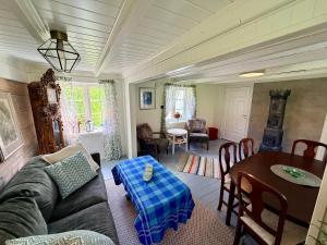 a living room with a couch and a table at The Haukland House, Between Peaks & Sea in Leknes