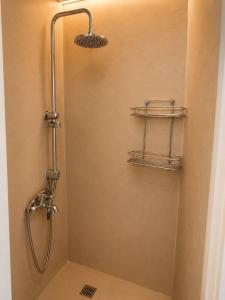 a shower in a bathroom with a glass door at Horn Agios Nikolaos in Agios Nikolaos