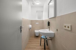 a bathroom with a sink and a toilet at K4 Jonava Rooms in Jonava +60 photos