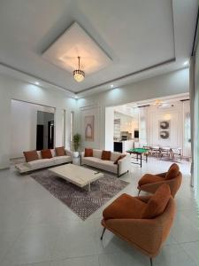 a large living room with couches and a table at The Serene Sanctuary in Kampala