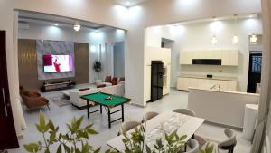 a kitchen and living room with a green table at The Serene Sanctuary in Kampala