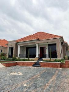 a house with a red roof and a brick driveway at The Serene Sanctuary in Kampala