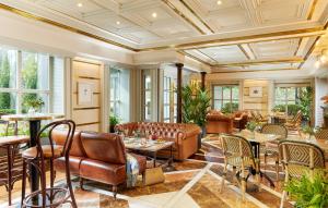 a living room with leather furniture and tables at Killarney Plaza Hotel & Spa in Killarney
