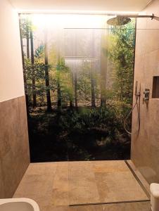 a bathroom with a shower with a view of a forest at Binterhof in Castelrotto +142 photos