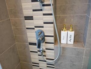 a shower with two bottles of soap in a bathroom at Robertson Luxury Apartment in Kuala Lumpur