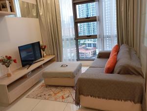 a living room with a couch and a television at Robertson Luxury Apartment in Kuala Lumpur