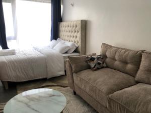 a living room with a couch and a bed at Tsavo Stanley, Kiambu La Mayan in Kiambu