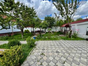 a garden with trees and a stone walkway at Gabala White House in Gabala