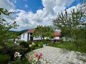 a house with a garden and a stone walkway at Gabala White House in Gabala