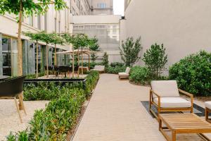 a patio with chairs and tables in a building at A-STAY Antwerp in Antwerp
