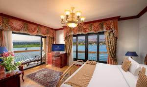 a living room with a bed and a large window at Sonesta St. George Hotel - Convention Center in Luxor