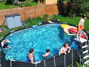a group of people in a swimming pool at Le rouge Robin in Fougax-et-Barrineuf