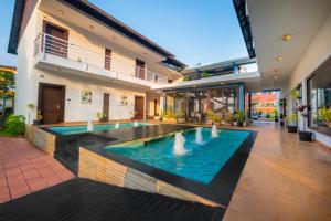 a pool in the middle of a house at The Ivy Anjuna in Anjuna