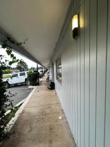 a hallway of a building with a person sitting on the sidewalk at Delight Inn Little Rock Benton I-30 in Benton