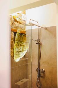 a bathroom with a shower with a glass door at Stone Villa Berat in Berat