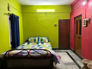a room with a bed in a room with green at Real City Homestay in Guwahati