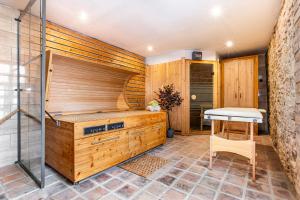 a sauna with a shower and a table at Resort Biskupský Dvůr in Višňová