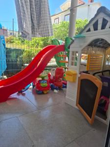 a childs play area with a slide and a playground at Radovići,Luštice in Radovici