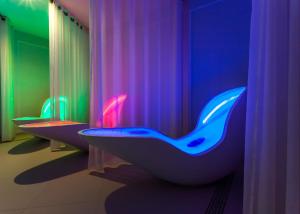 a bathroom with three sinks and a toilet with curtains at Pałac Żelechów Spa & Wellness in Żelechów