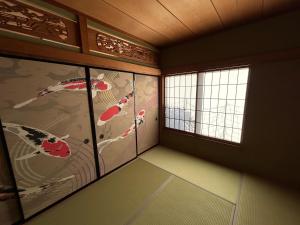 a room with two windows with kites on the wall at Fuji Hyakkei - Dream Bridge in Fuji +6 photos