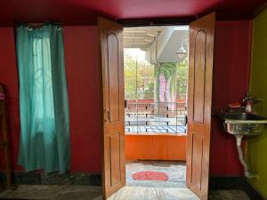 an open door to a bathroom with a sink at Real City Homestay in Guwahati +7 photos