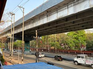 a bridge with a train on top of a highway at Real City Homestay in Guwahati