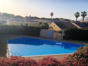 a large blue swimming pool on top of a house at Au village naturiste, Villa vue Marina in Cap d'Agde +11 photos