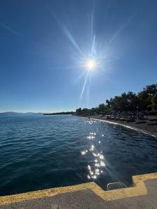 a view of a beach with the sun in the sky at The Village Corner in Politika