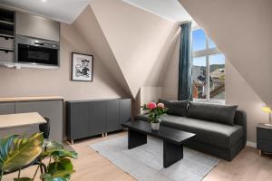 a living room with a couch and a table at Stay Byparken - Self-Service Hotel in Bergen