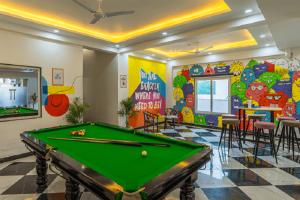 a billiard room with a pool table in the middle at Coco House in Greater Noida