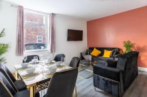 a living room with a table and a couch at Mauldeth Shared House in Manchester