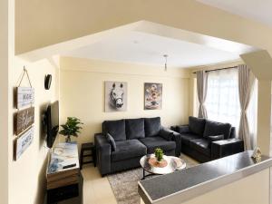 a living room with a couch and a table at Fahari House in Embu