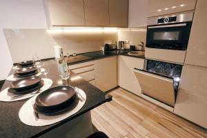 a kitchen with a counter with two plates and a stove at Casa Calma in Esztergom