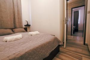 a bedroom with a bed with two towels on it at Casa Calma in Esztergom