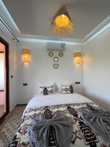 a bedroom with a large bed in a room at Qamar Mgouna Hotel in El Kelaa des Mgouna +4 photos