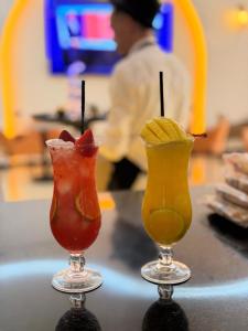 two cocktails sitting on top of a counter at Qamar Mgouna Hotel in El Kelaa des Mgouna