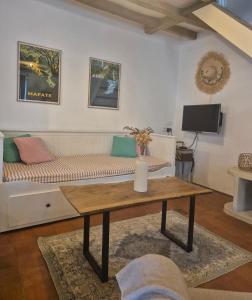 a living room with a couch and a table at Maison en bord de rivière in Cheffes-sur-Sarthe